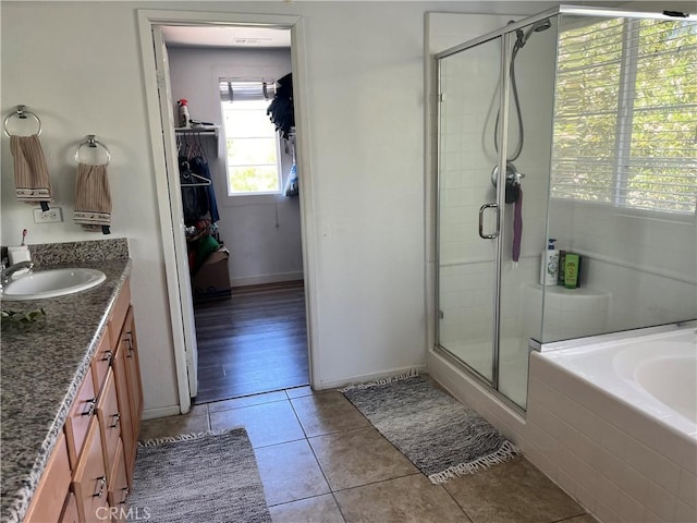 53209 Trailing Rose Dr, Lake Elsinore, CA 92532 - full bath featuring tile patterned flooring, a stall shower, vanity, a garden tub, and baseboards