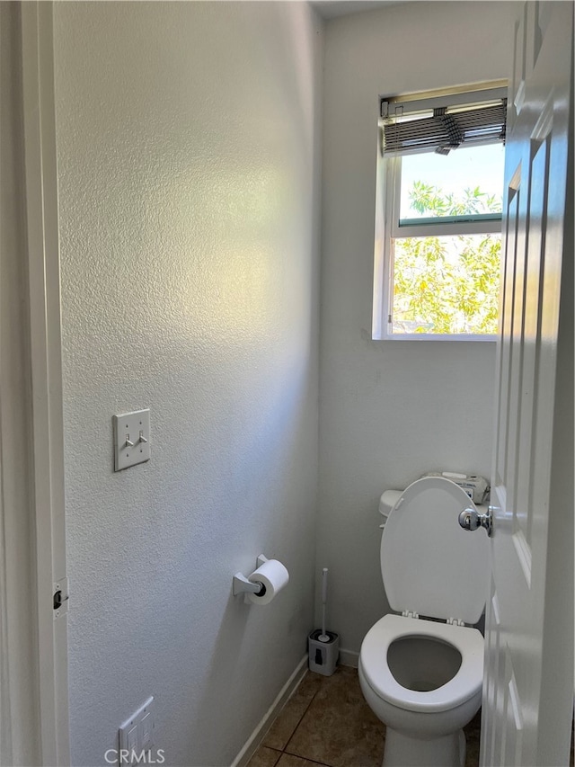 bathroom with tile patterned flooring and toilet