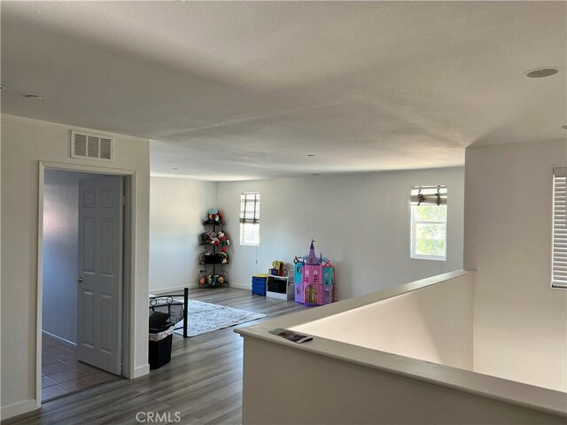 53209 Trailing Rose Dr, Lake Elsinore, CA 92532 - hall featuring dark wood-type flooring, healthy amount of natural light, and baseboards