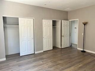 53209 Trailing Rose Dr, Lake Elsinore, CA 92532 - unfurnished bedroom with multiple closets, baseboards, and wood finished floors