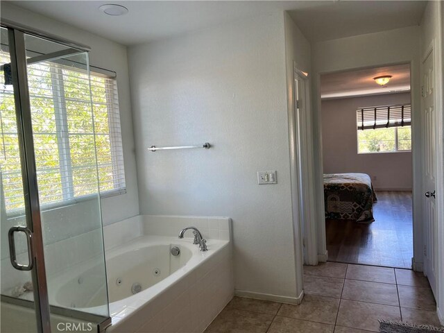 53209 Trailing Rose Dr, Lake Elsinore, CA 92532 - full bath with ensuite bath, tile patterned flooring, a whirlpool tub, and baseboards