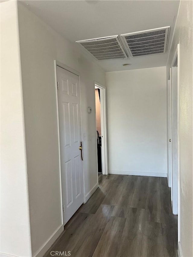 53209 Trailing Rose Dr, Lake Elsinore, CA 92532 - corridor featuring dark wood-type flooring and baseboards