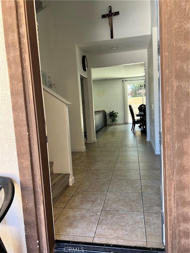 53209 Trailing Rose Dr, Lake Elsinore, CA 92532 - hallway with tile patterned flooring, stairway, and baseboards