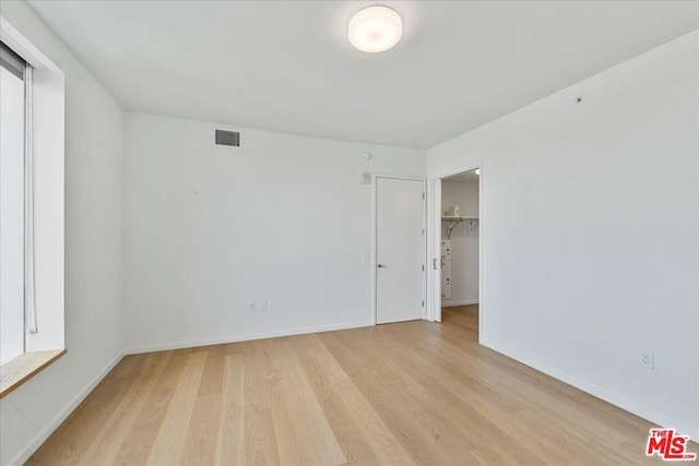 unfurnished room with light hardwood / wood-style flooring