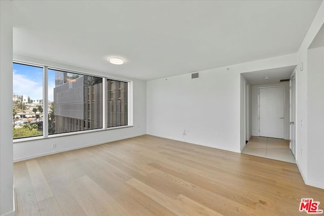 unfurnished room with light hardwood / wood-style floors