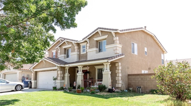 view of front of house featuring a porch, a garage, and a front lawn