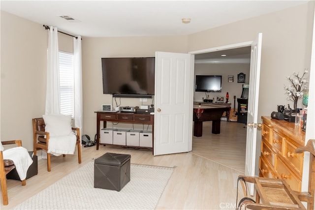 interior space featuring light hardwood / wood-style flooring and crown molding