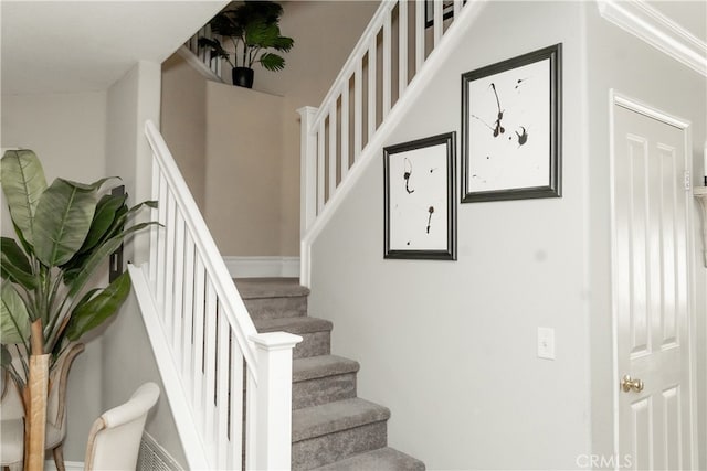 staircase featuring ornamental molding