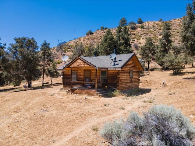 log home featuring a rural view and a mountain view