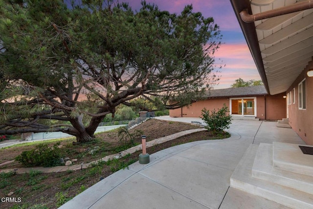 view of patio terrace at dusk