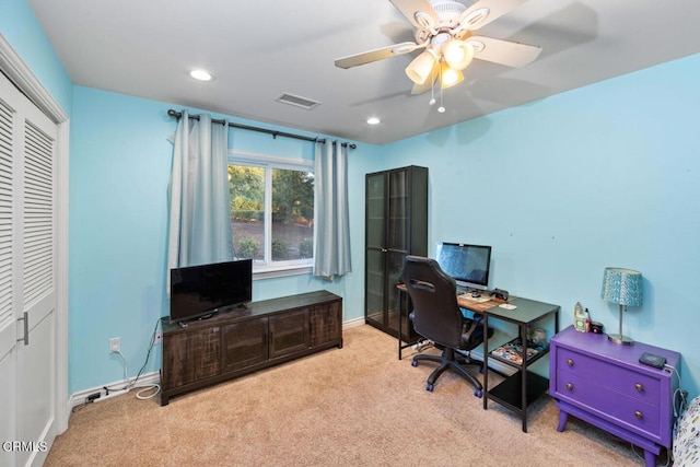 office space featuring light colored carpet and ceiling fan