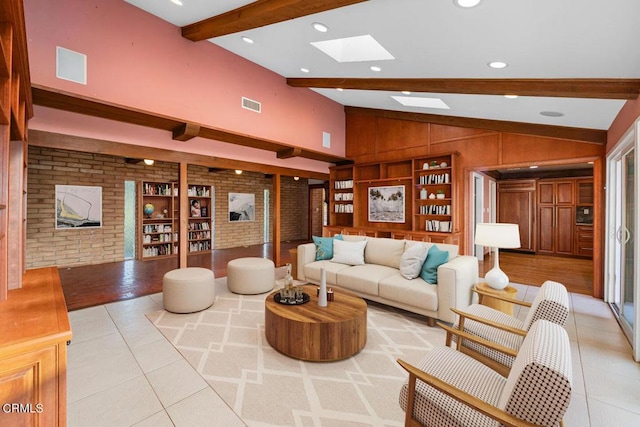 living room with built in shelves, lofted ceiling with beams, light tile patterned flooring, and brick wall