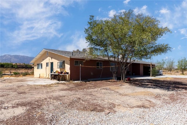 10925 Post Office Rd A/B, Unit A/B, Lucerne Valley, CA 92356 - view of side of property featuring stucco siding and a mountain view