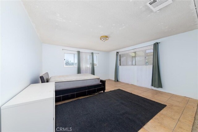 10925 Post Office Rd A/B, Unit A/B, Lucerne Valley, CA 92356 - tiled bedroom with a textured ceiling