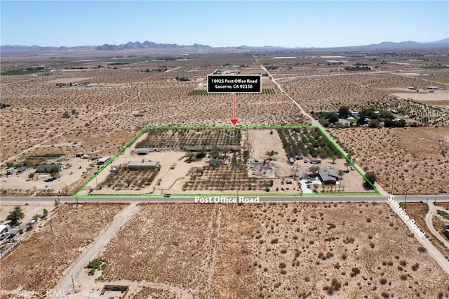 10925 Post Office Rd A/B, Unit A/B, Lucerne Valley, CA 92356 - aerial view of sparsely populated area featuring a mountain backdrop, property parcel outlined, and a desert landscape