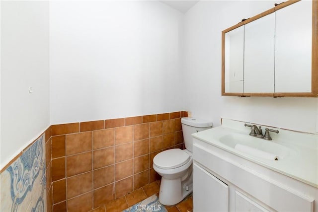 10925 Post Office Rd A/B, Unit A/B, Lucerne Valley, CA 92356 - bathroom with toilet, vanity, a wainscoted wall, and tile walls