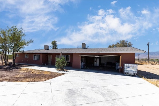 10925 Post Office Rd A/B, Unit A/B, Lucerne Valley, CA 92356 - ranch-style home with concrete driveway, an attached garage, and a chimney