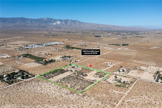 10925 Post Office Rd A/B, Unit A/B, Lucerne Valley, CA 92356 - overview of rural landscape with property parcel outlined, a mountainous background, and a desert landscape