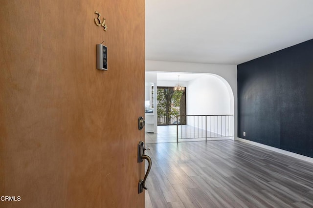 foyer entrance featuring an inviting chandelier and hardwood / wood-style flooring