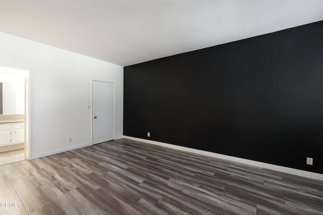 empty room with dark hardwood / wood-style floors