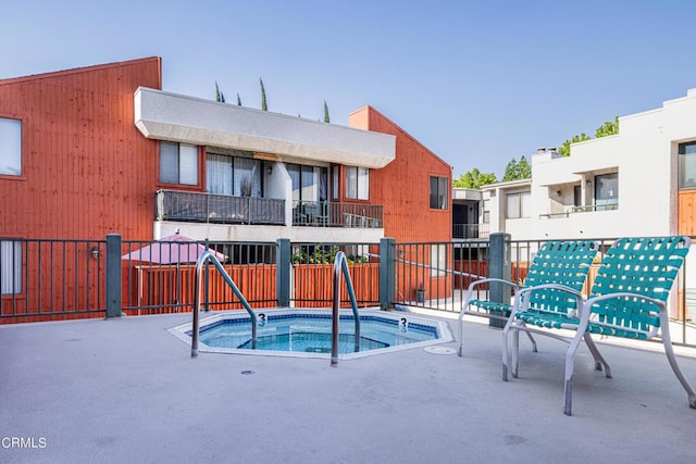 view of pool with a community hot tub