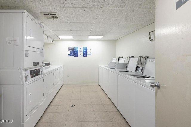 clothes washing area with washing machine and dryer and stacked washer and dryer