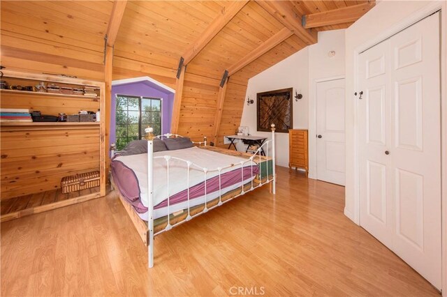 bedroom featuring hardwood / wood-style flooring, lofted ceiling with beams, and wooden ceiling