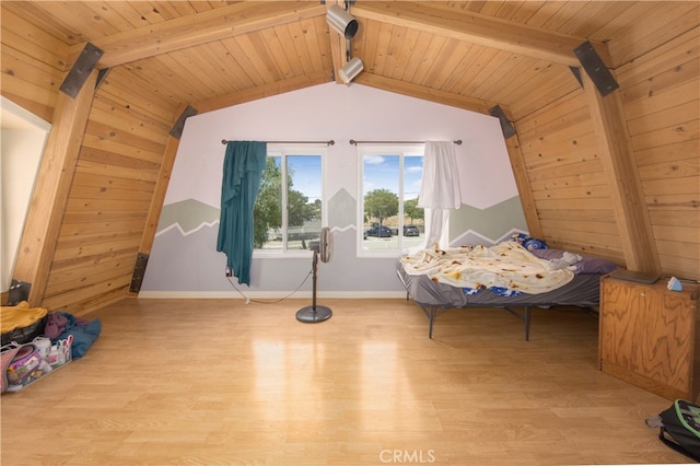 bedroom featuring light hardwood / wood-style flooring, lofted ceiling with beams, and wooden ceiling