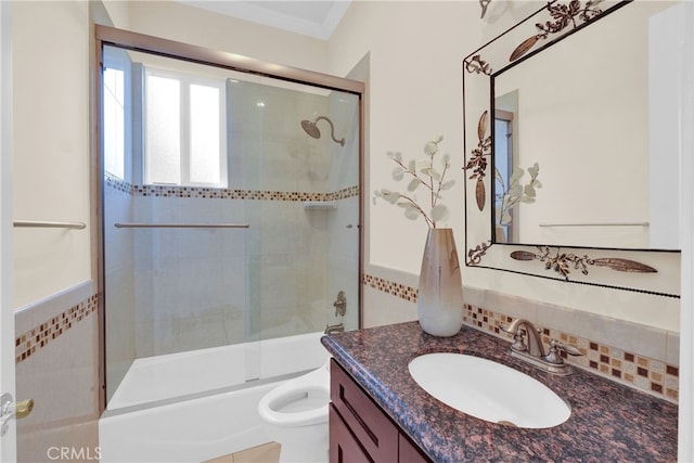 full bathroom featuring toilet, crown molding, vanity, and combined bath / shower with glass door