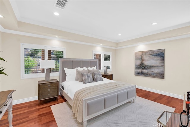 bedroom with hardwood / wood-style flooring and crown molding