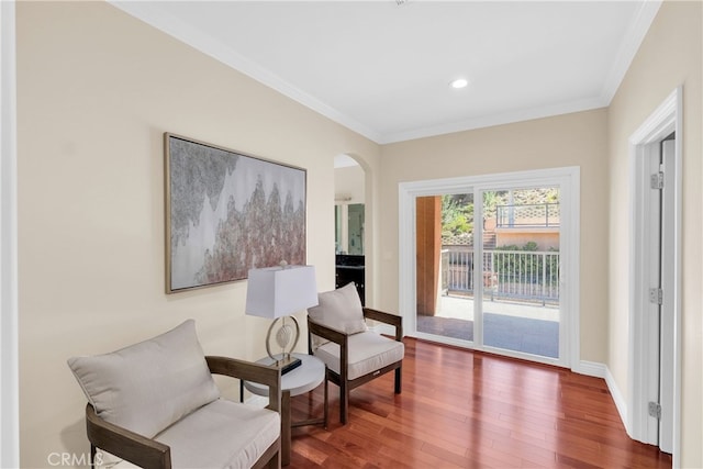 sitting room featuring crown molding and hardwood / wood-style flooring