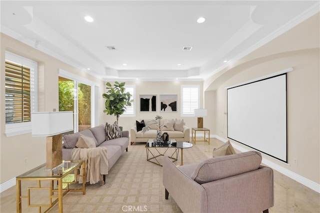 living room featuring a raised ceiling and crown molding