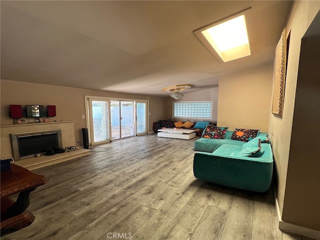 living room with wood-type flooring and vaulted ceiling