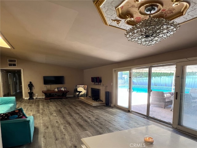 living room featuring hardwood / wood-style flooring and vaulted ceiling