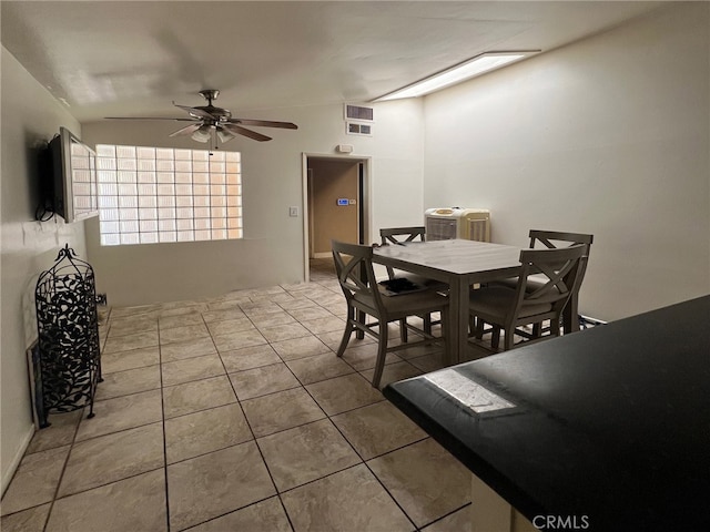 dining space featuring vaulted ceiling, ceiling fan, and tile patterned floors