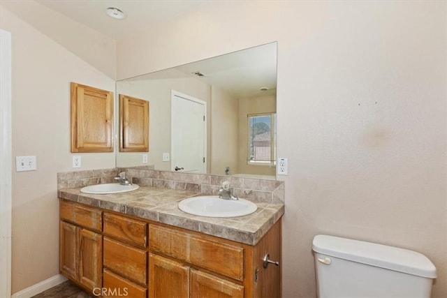 bathroom with vanity and toilet