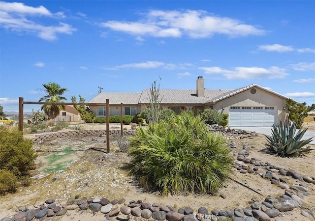 ranch-style home featuring a garage