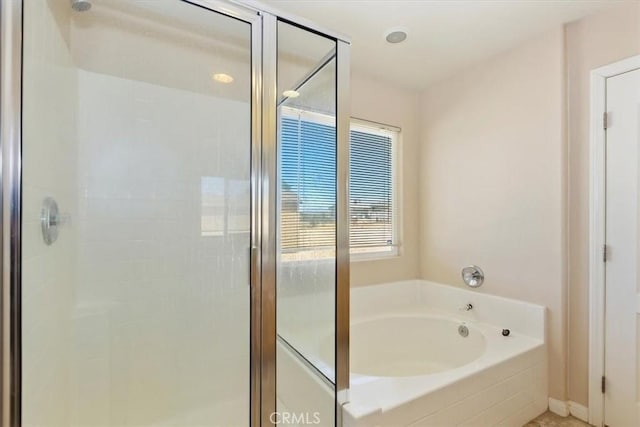 bathroom featuring separate shower and tub