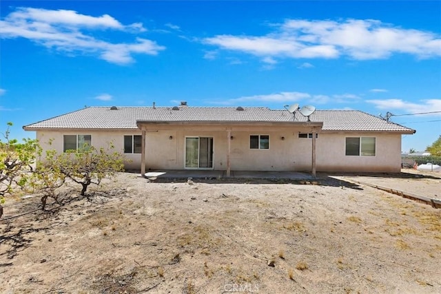 rear view of property featuring a patio area