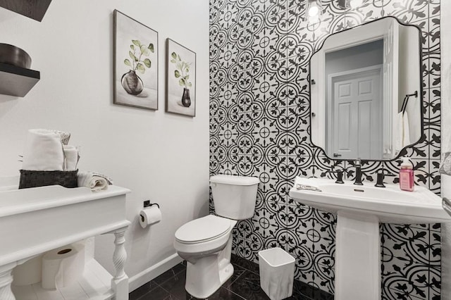 bathroom with toilet and tile patterned flooring