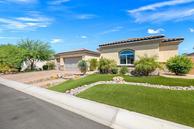 mediterranean / spanish-style house with a garage and a front yard