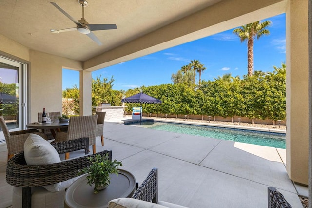 view of patio featuring ceiling fan and a fenced in pool