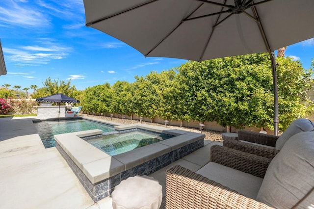 view of swimming pool featuring a patio area and an in ground hot tub