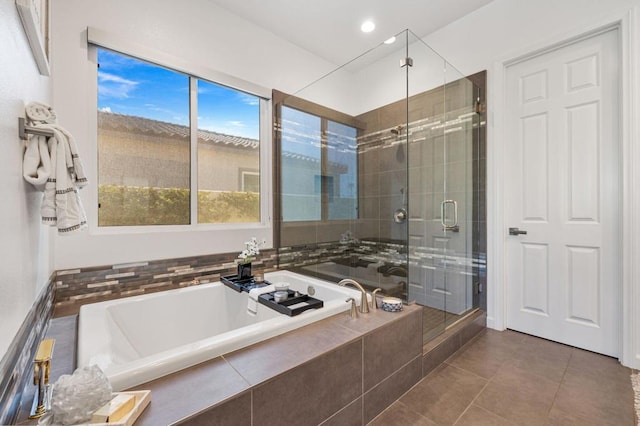 bathroom with tile patterned floors and independent shower and bath