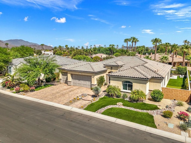 mediterranean / spanish-style home featuring a mountain view and a garage