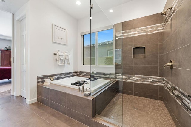 bathroom featuring tile patterned flooring and independent shower and bath