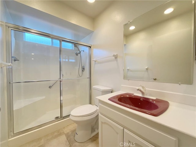 bathroom with vanity, toilet, tile patterned flooring, and an enclosed shower