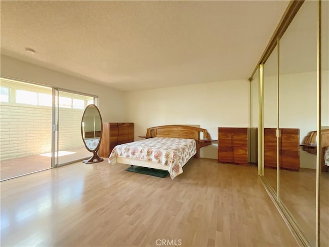 bedroom featuring a textured ceiling and wood-type flooring