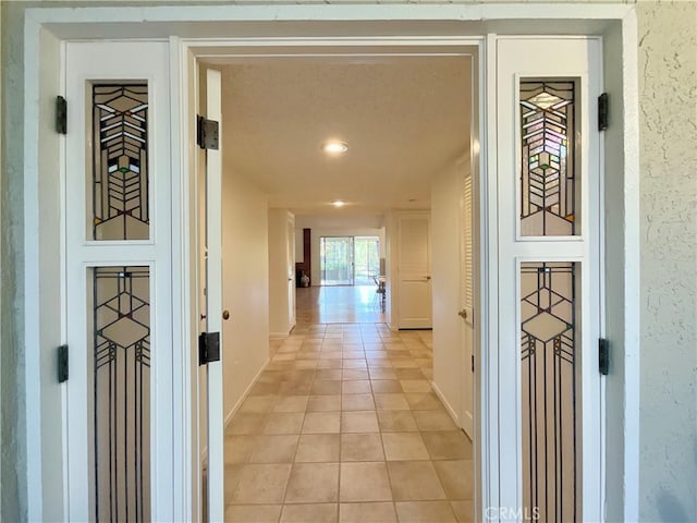 hall with light tile patterned flooring