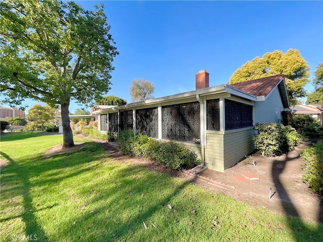 view of side of home featuring a lawn